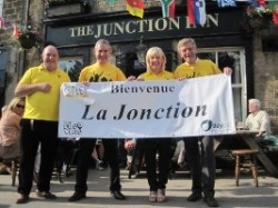 Tony and Melanie Grey from the Junction accepting their French banner from Otley Pub Club  president Greg Mulholland and committee member Andrew McKeon. 