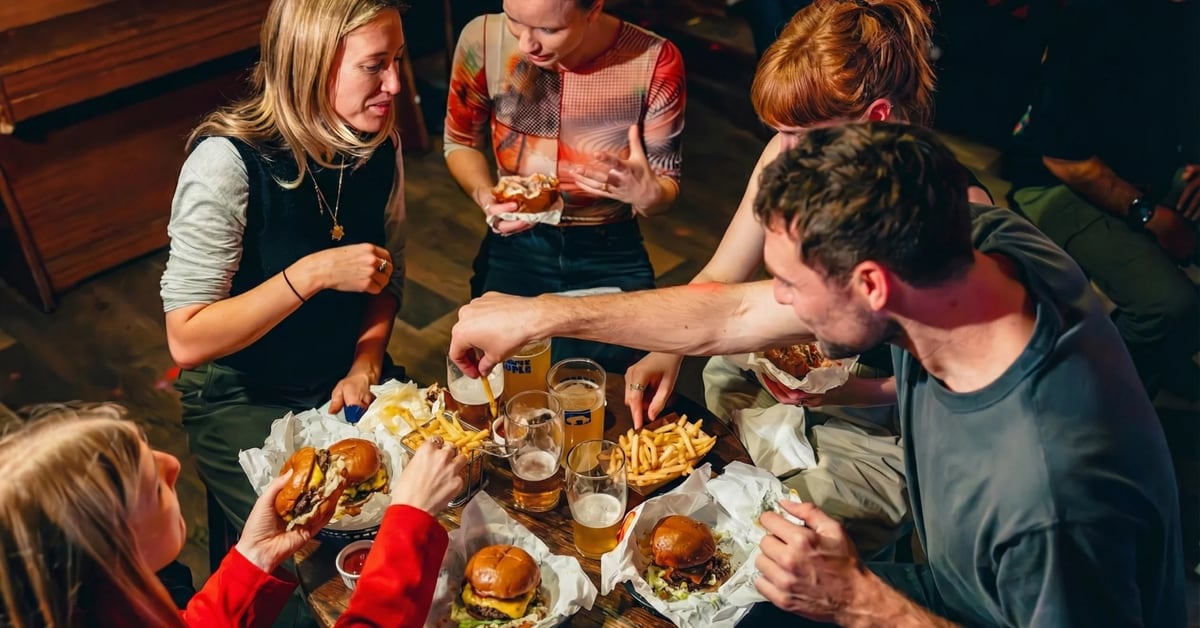 Friends sharing food around a pub table