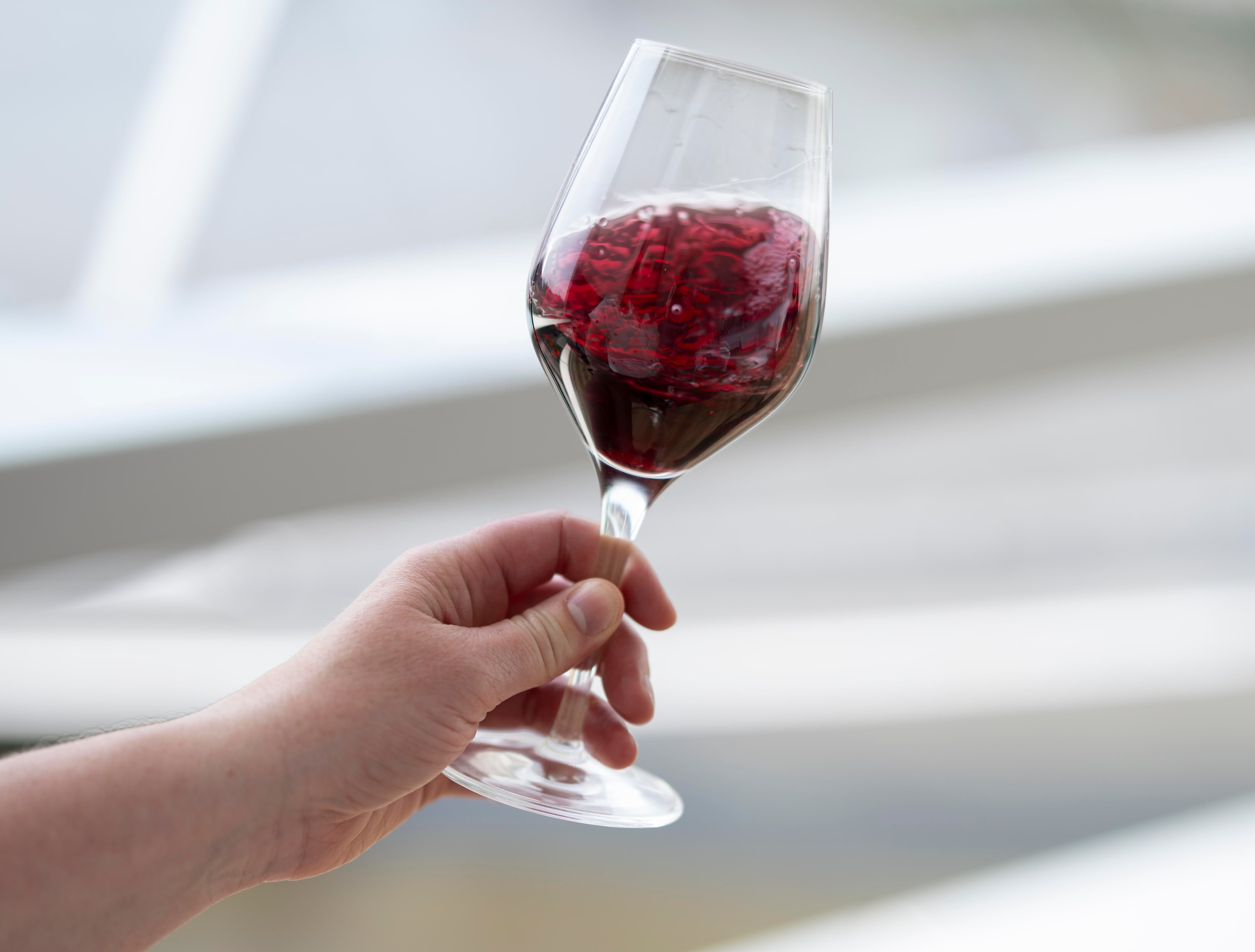 Red wine swirling in glass