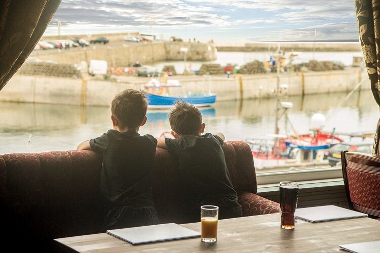 9-Customers-enjoy-a-drink-with-a-view-of-Seahouses-harbour-at-The-Bamburgh-Castle-Inn-2.jpg