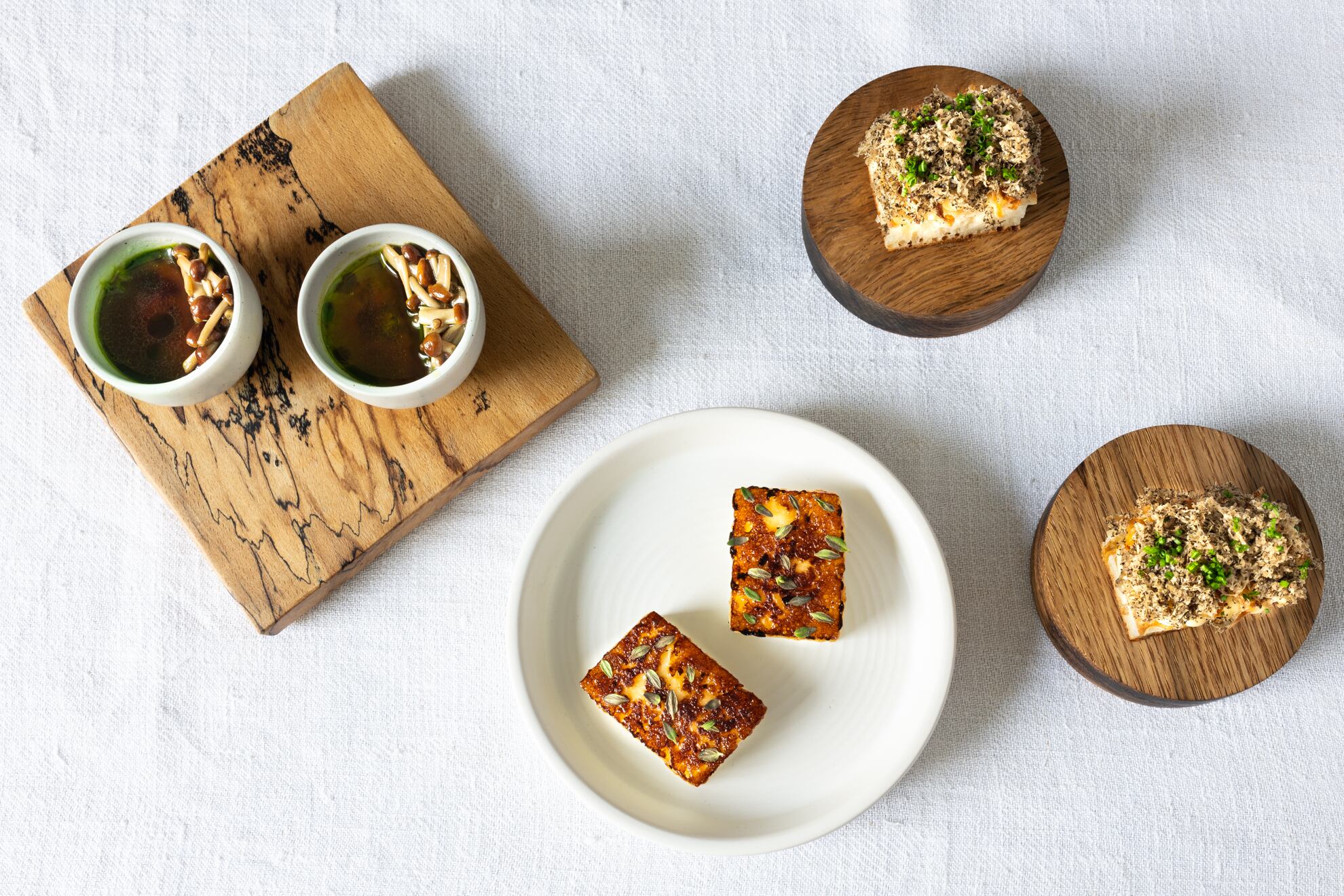 Oxtail and thyme custard, bone marrow enoki, tarragon - Gotty's queakey cheese glazed in thyme honey - Baron Bigod and truffle crumpet credit Jenny Jones Photography