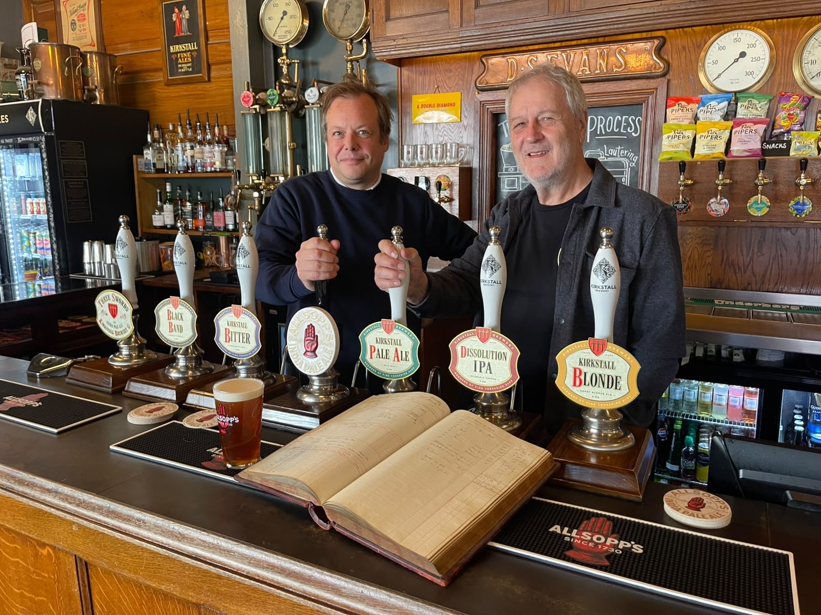 (l-r) Jamie Allsopp and Steve Holt with the Allsopp's ledger