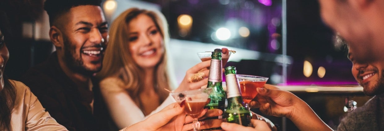 Friends in pub doing cheers with drinks