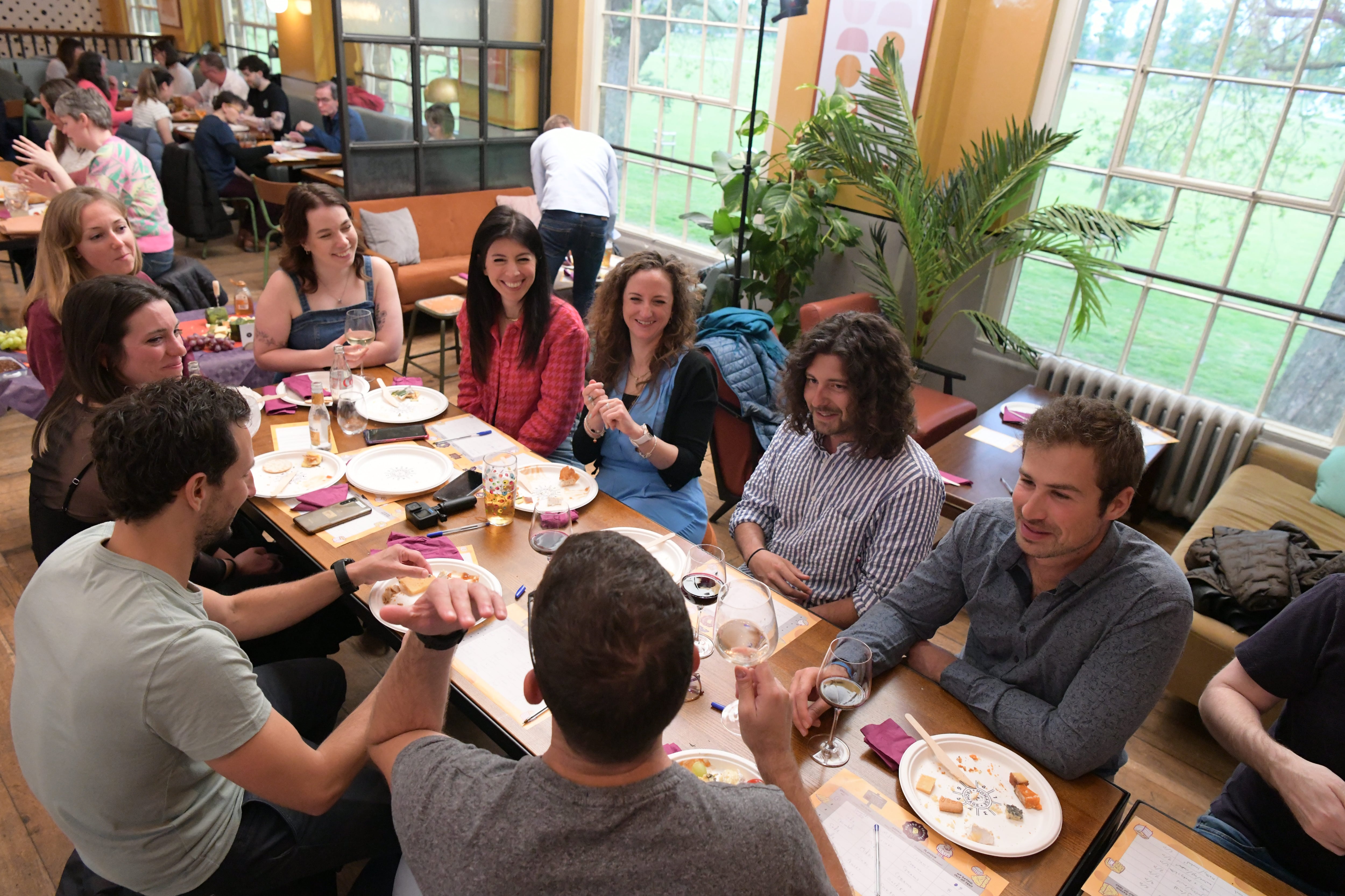 Friends sitting round a table eating and drinking