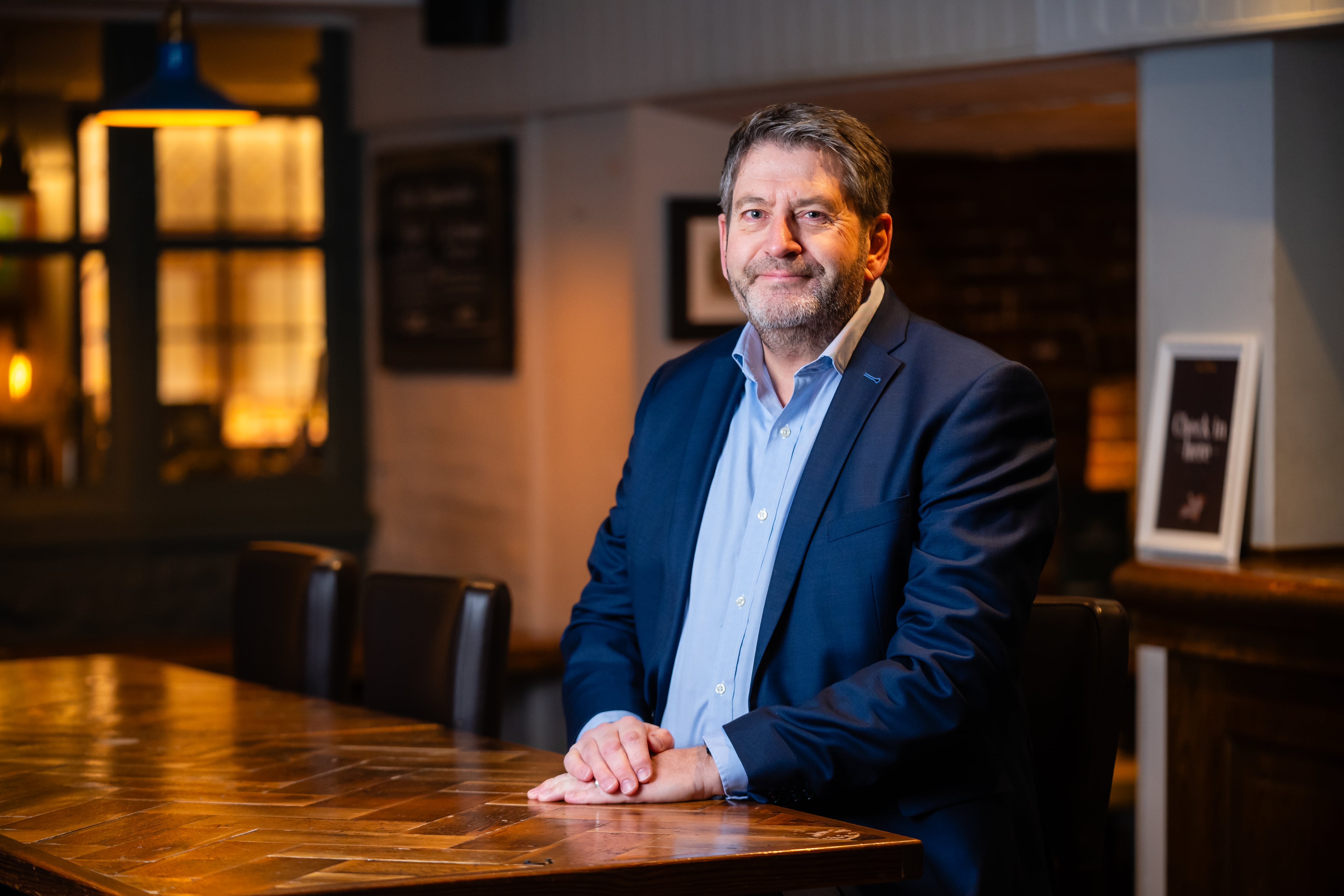 Andrew Bush, chief experience officer at Greene King in a business setting.