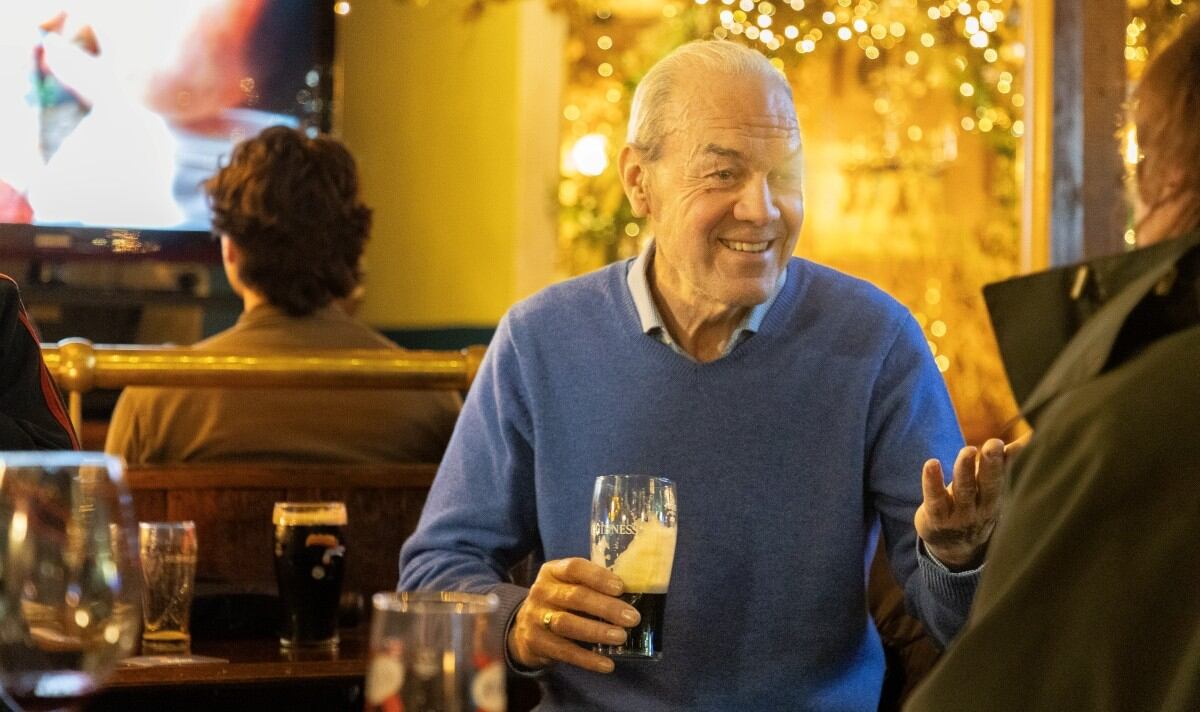 Man drinking pint of Guinness in pub