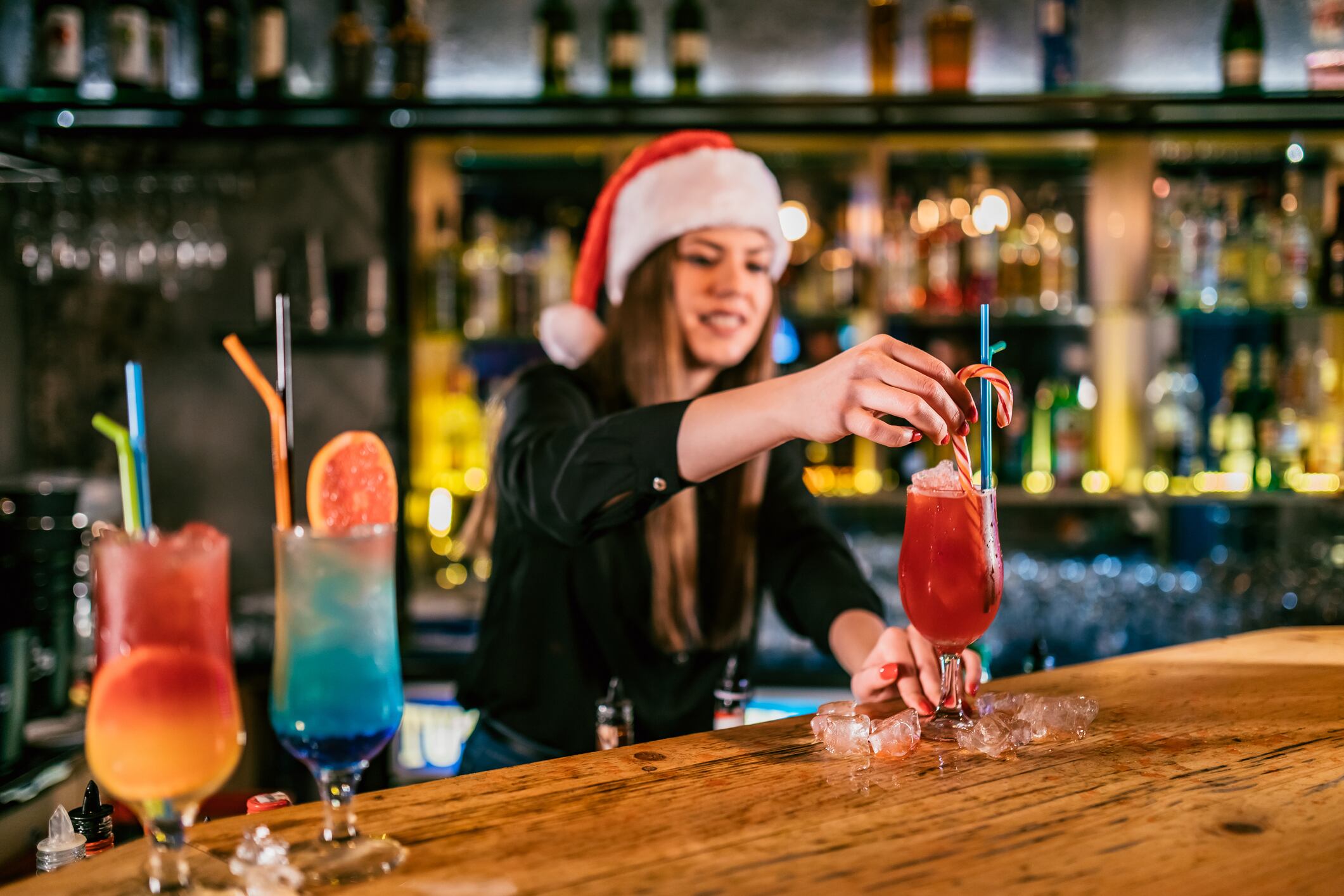 Female bartender making cocktails