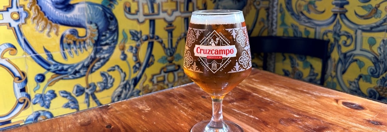 Cruzcampo beer in glass on table