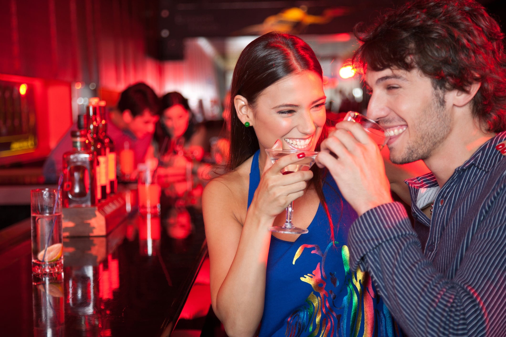 Smiling couple in nightclub with beverage