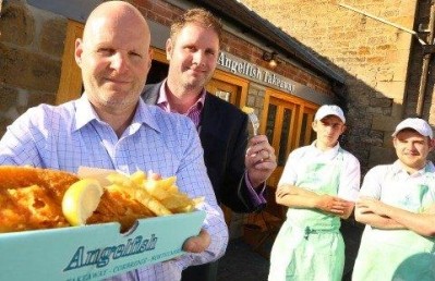 Frying delight: Angel Inn boss Kevin Laing (left) with a customer and Angelfish staff