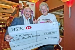Barry McGuigan colected the cheque from Wetherspoon's founder and chairman Tim Martin