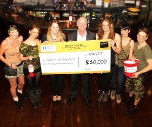 Donation: TCG's Nigel Wright (fourth from left) at Henry’s Café Bar in Covent Garden presenting a cheque to Sophie Parry of Help for Heroes (third from left), with barstaff Shauna and Kitti (left) and Victoria, Francesca and Dom (right). 