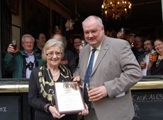 Bridget Walsh receives her award from CAMRA's pubs director Julian Hough