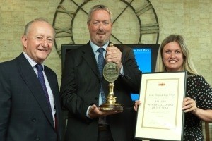Fuller's chairman Michael Turner presents licensees Angus McKean and Claire Morgan with their award