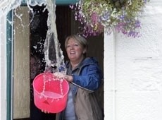 Karen Burnett of the Fox & Hounds near Greenside, Gateshead, bailing out water from her pub