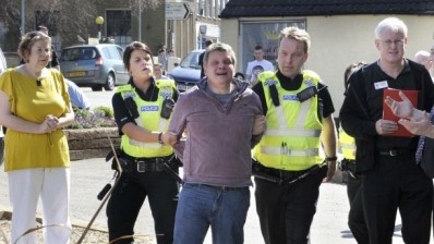 Nigel Marsh is led away by police 
