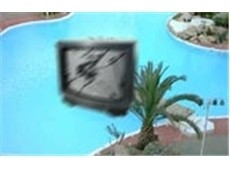 A TV about to hit a hotel swimming pool