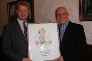 Giles Kendall (right) presenting the caricature to James Clarke