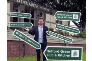 Signs: Scott Whittaker of the Wilford Green Pub & Kitchen models his road signs