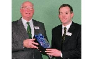 Gordon Hepburn receives an engraved decanter for his years of work to the Guild of Q.