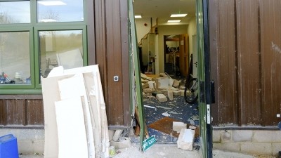 Scene of devastation: thieves dragged a floor-bolted safe through the wall containing £6,000 cash