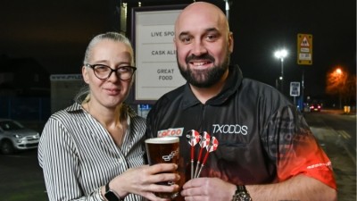 Taking centre stage: licensee Kirsten Duncan with darts player Jamie Hughes