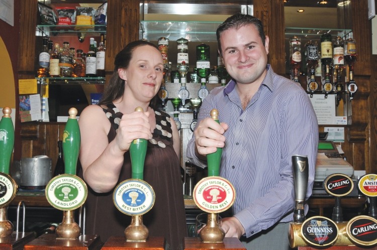 Working a shift: Trudy Pilmoor, licensee of the White Swan in Fence, Lancashire with MP Andrew Stephenson