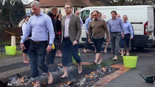 Marston's head office staff take part in a fire walk 