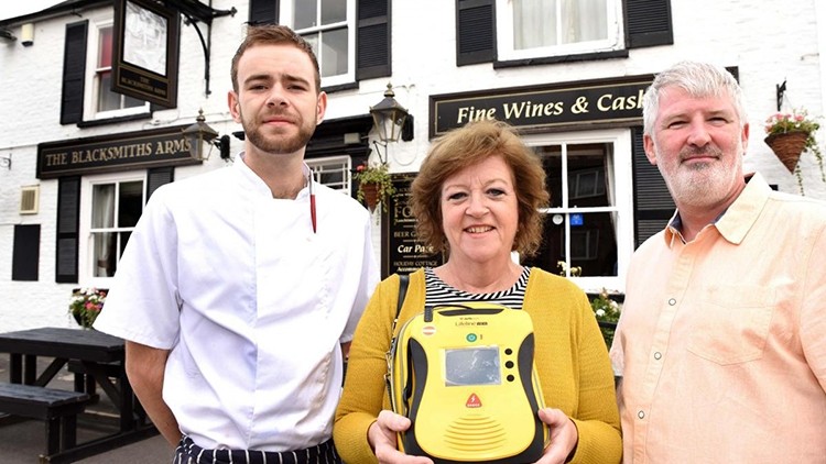 Heartwarming tale: Blacksmith Arms chef James Priest, parish councillor Anne Clark and pub licensee Tony Buckley saved the diner's life (image: The Press, York)
