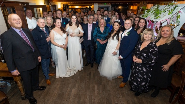 Huge milestone: Philippe and Janet Sorak (centre) with 30 couples who married at the Barn pub 