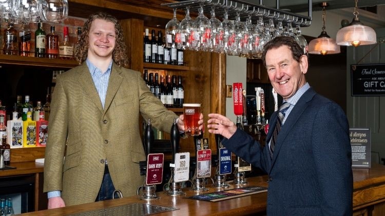 Marked event: Adam Hyde is served a pint from apprentice brewer and nephew Tom Allkins to celebrate Hydes' 160th anniversary