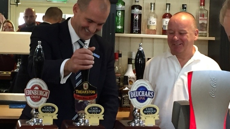 Online taxation plan: pubs minister Jake Berry pulls a pint at the Woolpack, Haslingden, Lancashire