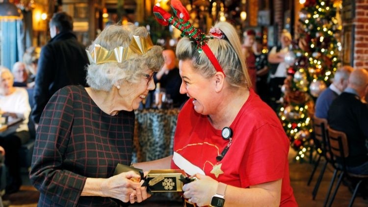 She’s a cracker: 90 year old Audrey Dobson enjoys a Christmas party for older people in Sunderland with Debbie Brown of The Seaburn Inn (Credit: Stuart Boulton)