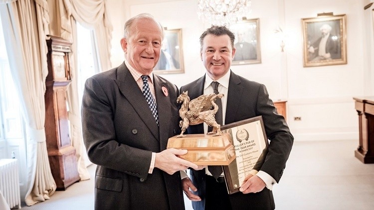Griffin Trophy: Fuller's chairman Michael Turner (left) presents Marc Duvauchelle of the Old Customs House with the 2017 Pub of the Year prize
