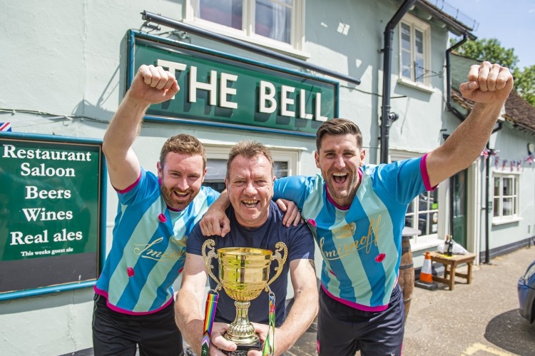 Graham Bedford, licensee of the Bell Inn, with the GK Carling Cup and winning team members from Diageo