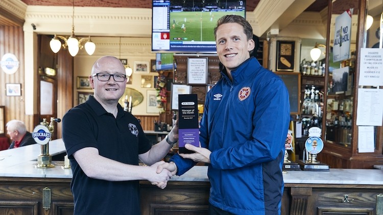 Hearts of the community: Kevin McGhee (left) is presented with his award by Scotland and Hearts ace Christophe Berra