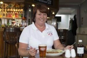 Licensee Dawn James tucks into one of the pubs new pies from M. Manze