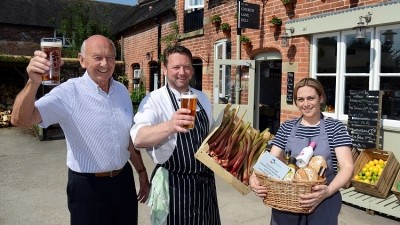 Serving the community: Hugh Wilson (l) from Pub is the Hub with Robin and Terri Hunter at the Church Lane Deli