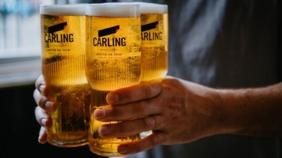 Un-beer-lievable: Carling's new pint glass design means you can safely carry up to four pints at a time