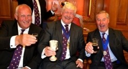 Previous Masters Stephen Goodyear (left) and Mark Woodhouse (right) toast James Arkell's appointment. Picture by Hy Money