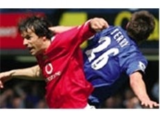 Ruud van Nistelrooy and John Terry jump for a ball