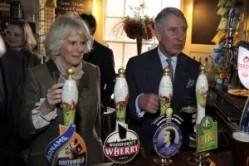 Prince Charles and Camilla pull pints at the Purleigh Bell 