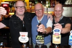 John Pilkington (centre) with the landlords of the Britannia Inn and his personalised pump clip