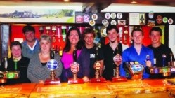 All smiles: MP Caroline Nokes, fourth from the left, with the team at the Hatchet Inn