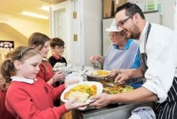 Kevin Hillyer, head chef at the Black Swan in Ravenstonedale, Cumbria, dishes up lunches at the local school